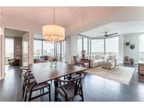 Bright living room with hardwood floors, modern furnishings, and city views from large windows at 2795 Peachtree Ne Rd # 1009, Atlanta, GA 30305