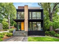 Modern two-story home featuring large windows, stone accents, and manicured landscaping at 819 Belgrade Ne Ave, Atlanta, GA 30306