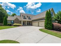 Charming home featuring lush landscaping, a wide driveway, and a welcoming front porch at 200 Glenview Ct, Woodstock, GA 30188