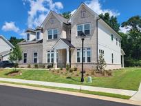 Beautiful two-story home featuring a landscaped lawn and a combination of brick and siding at 2949 Longbush, Duluth, GA 30097