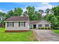 Charming single-story home featuring gray siding, black shutters, and a well-manicured lawn at 3333 Old Salem Se Rd, Conyers, GA 30013