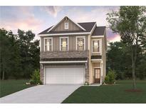 Charming two-story home with brick and siding, features a two-car garage, and a well-manicured lawn at 1886 Copelyn Reese Court (Lot 165), Lawrenceville, GA 30043