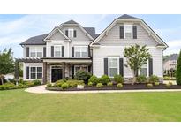Charming two-story home with a well-manicured lawn and inviting curb appeal at 6840 Canyon Creek Way, Cumming, GA 30028