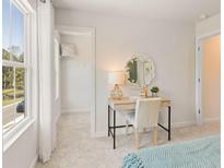 Bright bedroom features a vanity, accent mirror, and a walk-in closet at 1884 Copelyn Reese Court (Lot 166), Lawrenceville, GA 30043