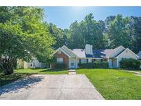 Charming single story home with brick and vinyl siding, manicured lawn, and a long driveway at 1249 Scripps Sw Ct, Marietta, GA 30008