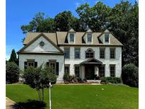 Charming white brick two-story home with manicured lawn and inviting covered porch at 2968 Ovalene Sw Ct, Marietta, GA 30064