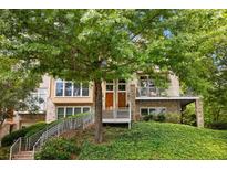 Charming townhouse with well-manicured lawn and two entrances with iron handrails leading up to the front doors at 1354 Fernwood Ne Cir, Brookhaven, GA 30319