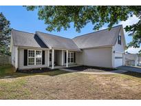 Charming one-story home with neutral siding, inviting front porch, and well-maintained lawn at 257 Se Ashland Park Se Ct, Lawrenceville, GA 30045