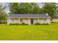 Charming single-story home featuring a well-manicured lawn and neutral exterior paint at 225 Fireside Way, Fairburn, GA 30213