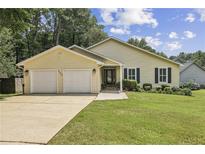 Charming single-story home with a well-manicured lawn, attached two-car garage, and inviting front entrance at 255 Broken Lance Pl, Johns Creek, GA 30022