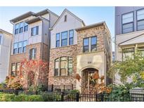 Elegant two-story townhome featuring a brick facade and manicured landscaping at 621 Broadview Ne Ter, Atlanta, GA 30324