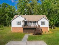 Charming home featuring a front porch with a brick foundation and well-manicured lawn at 4408 Brandon Ne Ct, Marietta, GA 30066
