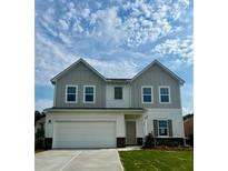 Charming two-story home with a large garage and a well-maintained lawn at 119 Champions Blvd., Dallas, GA 30157