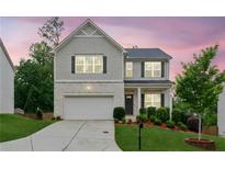 Charming two-story home with a manicured lawn and a two-car garage, offering curb appeal at 6360 Boulder Rdg, Cumming, GA 30028