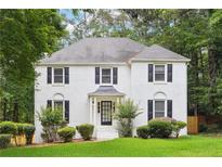 Charming white brick home with well-manicured lawn and mature trees offering great curb appeal at 2745 Saxon Drive, Duluth, GA 30096