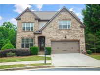 Charming two-story brick home with a well-manicured lawn and a two-car garage at 3920 Baverton Dr, Suwanee, GA 30024