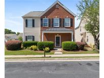 Charming two-story home with brick and vinyl siding, black shutters, and well-maintained landscaping at 3223 Tallon Sw Ln, Atlanta, GA 30311