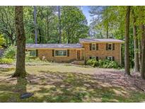 Charming brick home with a well-manicured front yard surrounded by mature trees at 3362 Northbrook Dr, Atlanta, GA 30340