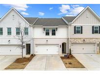Charming townhouse showcasing a brick facade, attached garage, and well-manicured lawn at 3610 Silvery Way, Powder Springs, GA 30127