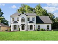 A charming home featuring a manicured lawn and striking black and white color scheme at 4168 Arapaho Dr, Powder Springs, GA 30127
