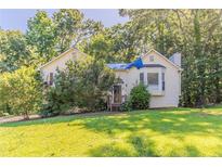 Charming home with a well-maintained front yard, lush greenery, and inviting front porch at 42 Breckenridge Dr, Powder Springs, GA 30127