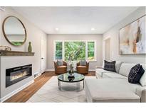 Inviting living room featuring a fireplace, hardwood floors, and large windows offering plenty of natural light at 522 Stell Rd, Woodstock, GA 30188