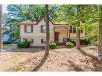 Charming two-story home with brown shutters and a manicured lawn at 142 Wellspring Pt, Hiram, GA 30141