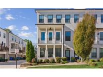 Beautiful gray brick townhome with a small front yard and two-story porch at 2034 Rockledge Ne Rd, Atlanta, GA 30324