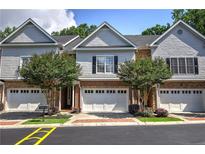 Charming townhome with brick facade, manicured landscaping, and attached garages at 5492 Glenridge Dr # 536, Atlanta, GA 30342