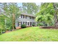 Charming two-story home with beautiful lawn, manicured shrubs, and a symmetrical facade at 2041 Millspring Nw Way, Kennesaw, GA 30152