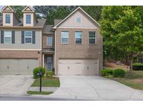 Charming brick home featuring a two-car garage and well-maintained landscaping at 3982 Brockenhurst Dr, Buford, GA 30519