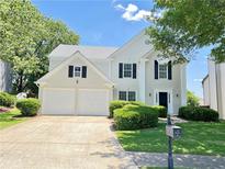 Charming two-story home with a well-manicured lawn, two-car garage, and beautifully landscaped yard at 2130 Chattahoochee Dr, Duluth, GA 30097