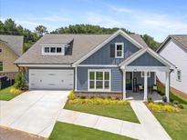 Charming one-story home featuring a two-car garage, landscaped yard, and a welcoming front porch at 302 Bunker Hill Ct, Acworth, GA 30102