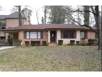 Charming single-story brick home with a cozy covered carport, well-maintained landscaping, and a welcoming entrance at 1253 Dunwoody Ne Ln, Brookhaven, GA 30319
