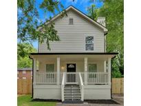 Charming two-story home featuring a welcoming front porch, freshly painted siding, and a well-maintained yard at 786 Neal Nw St, Atlanta, GA 30318
