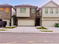 Charming townhome with brick and shingle siding and two-car garage, offering modern curb appeal at 181 Dewy Rd # 70, Lilburn, GA 30047
