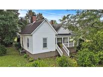 Charming exterior view of home, showing the front porch and well-maintained landscaping at 2 N Broad St, Porterdale, GA 30070
