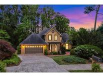 Charming stucco home with a lush landscaped yard and a two-car garage at 2366 Battle Forest Sw Dr, Marietta, GA 30064