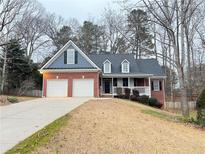 Charming brick home with a two-car garage and welcoming front porch; perfect for suburban living at 6745 Fairfield Trce, Suwanee, GA 30024