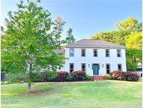 Beautiful two-story home with a bright green lawn and meticulously kept landscaping at 1495 Oak Springs Dr, Marietta, GA 30066