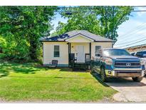 Charming single story home with a well-maintained lawn and tidy landscaping, a relaxing place to call home at 1357 Railroad Ave, Sugar Hill, GA 30518