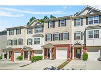 Charming townhomes boast brick accents, garages, and well-manicured lawns at 6887 Slate Stone Se Way # 3, Mableton, GA 30126