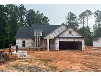 New home under construction with a large garage, set on a wooded lot at 610 Presley Farm Pkwy, Rockmart, GA 30153