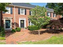 Charming brick townhome featuring a landscaped front yard and inviting entrance at 1223 Whitlock Ridge Sw Dr, Marietta, GA 30064