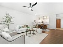 Bright living room featuring hardwood floors, a ceiling fan, and contemporary furnishings at 273 12Th Ne St # 114, Atlanta, GA 30309