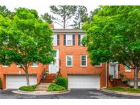 Charming brick townhome with a well-maintained yard and attached garage at 3833 Savannah E Sq, Atlanta, GA 30340