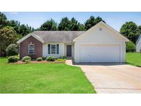 Charming single-story home with a brick accent, manicured lawn, and attached two-car garage at 424 Yellow River Walk, Lawrenceville, GA 30043