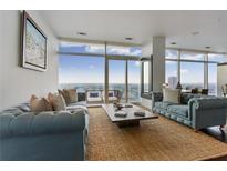 Bright living room with floor to ceiling windows and an outdoor terrace to enjoy the city views at 45 Ivan Allen Jr Blvd # 2203, Atlanta, GA 30308