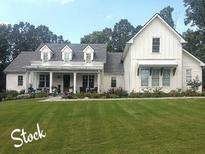 Charming farmhouse exterior with a welcoming front porch and well-manicured lawn and appealing architectural details at 2226 Upper Burris Rd, Canton, GA 30114