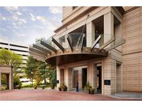 Elegant building entrance with a unique awning and landscaped surroundings offers a grand arrival experience at 3376 Peachtree Ne Rd # 35A, Atlanta, GA 30326